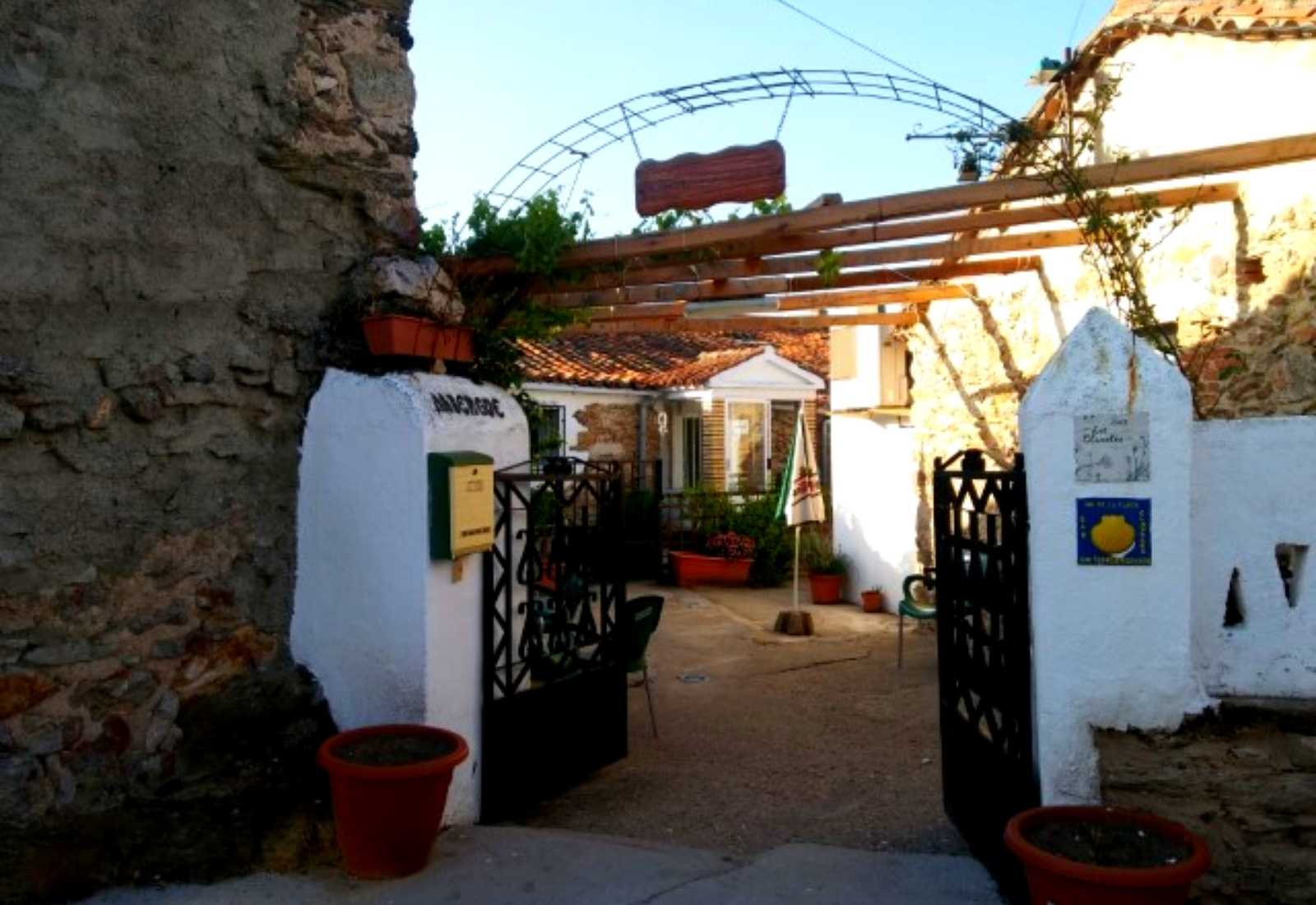 Entrance to a pilgrims' hostel with the Camino scallop shell and courtyard on the Vía de la Plata stage to Salamanca