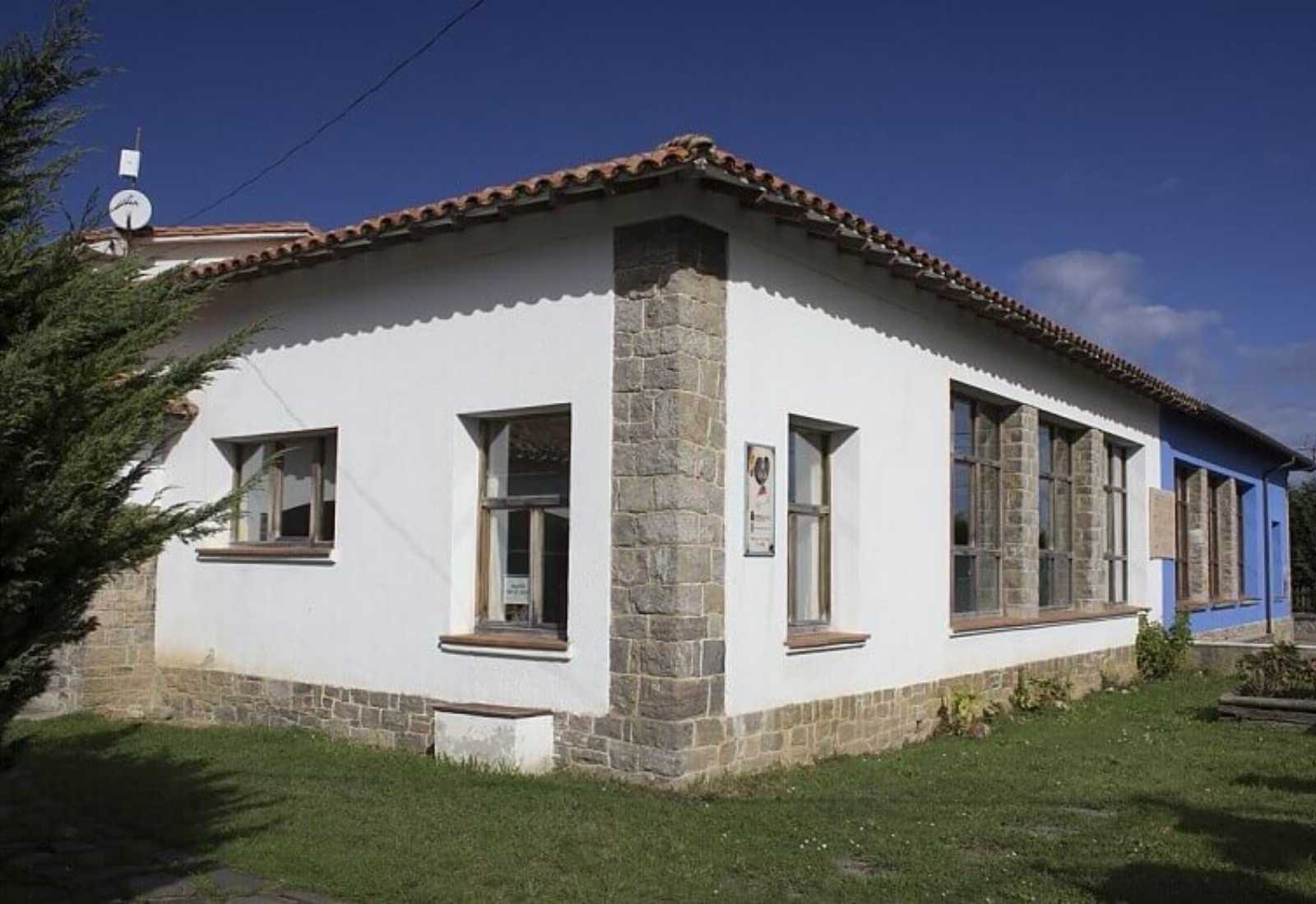 Pilgrims' hostel, a white building with stone corners and a red roof, on the Ribadesella to Colunga stage of the Camino del Norte.