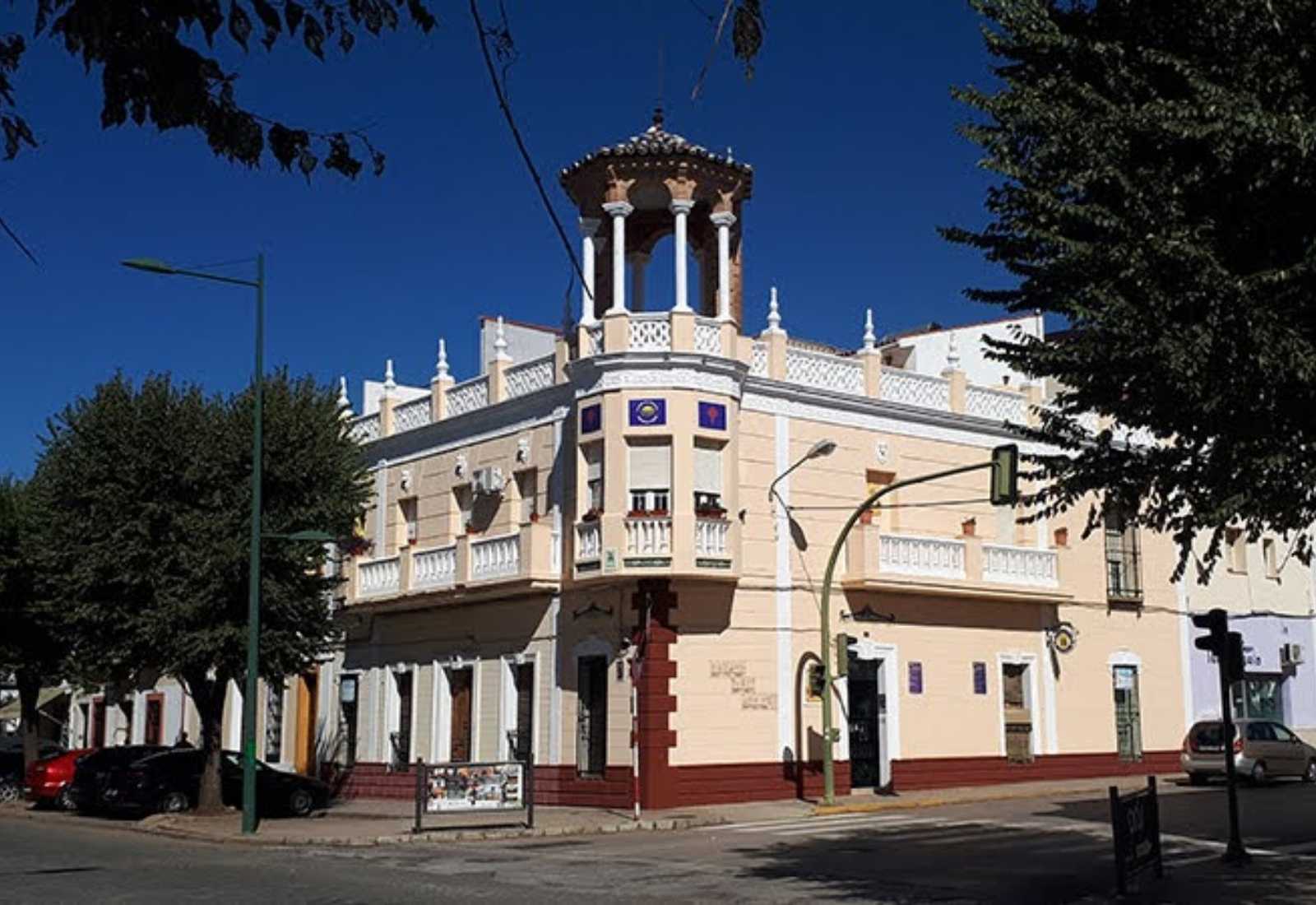 Stately corner building with a turret and balustrades housing a hostel on the stage From Zafra to Villafranca de los Barros.