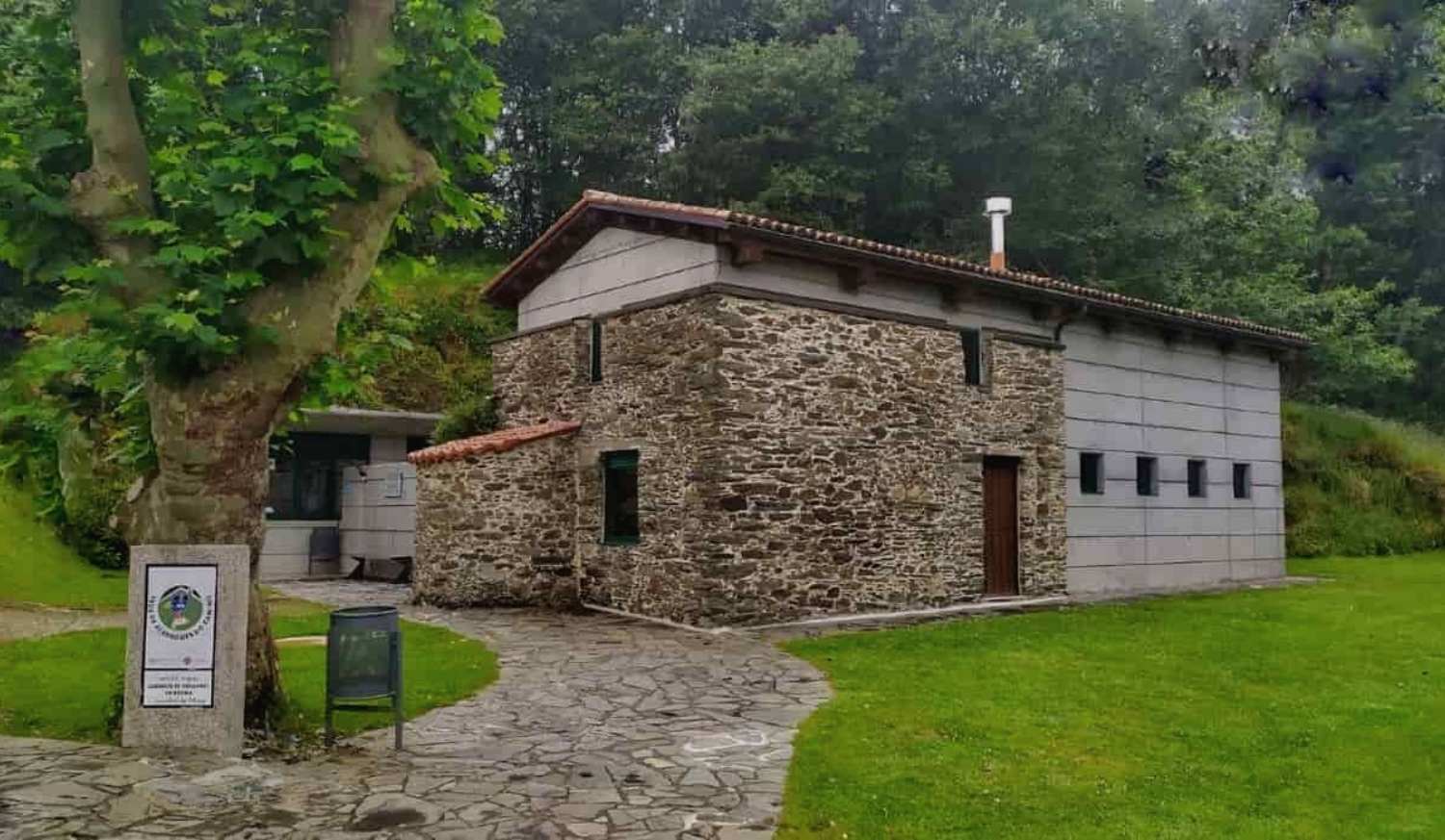 Steinherberge in Hospital de Bruma umgeben von Grün und Nebel am Ende der Etappe von Betanzos, Englischer Weg