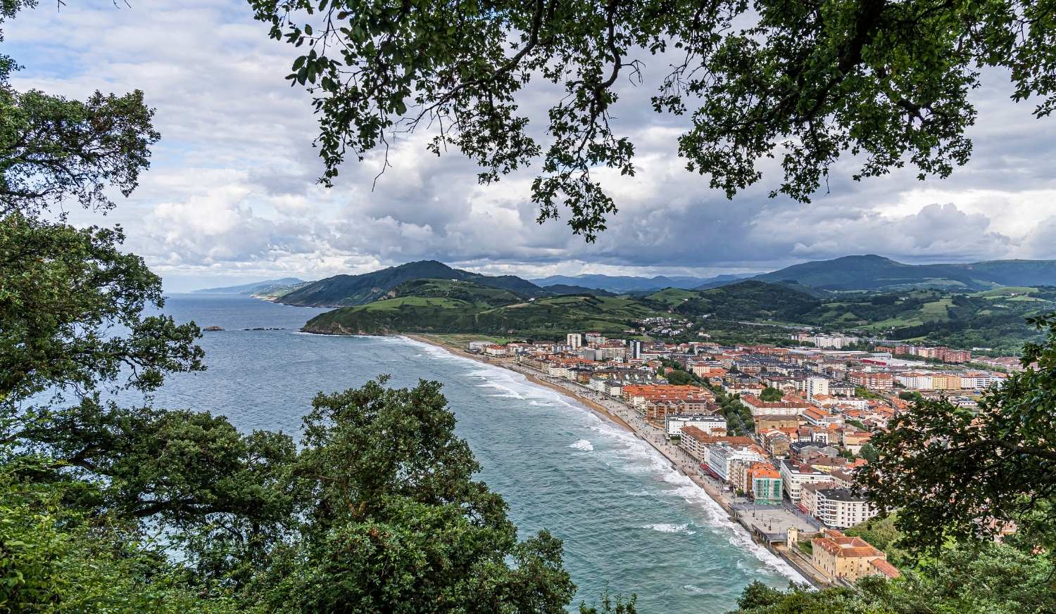 Vue panoramique de Zarautz et de sa longue plage encadrée d'arbres, étape de Zarautz à Deba du Camino del Norte
